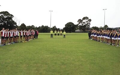 AJAX and Williamstown CYMS men's players hold a minute's silence before their match last Saturday at Moorleigh Reserve, to mark Yom Hashoah. Photo: Peter Haskin