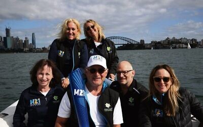 A 21st Maccabiah torch gets a boat ride on Sydney Harbour. Pictured with it are (back, from left) Giselle Berlinski, Lauren Ehrlich (front, from left) Debbie Rutstein, Barry Smorgon, Sam Gamsu and Jillian Sher.