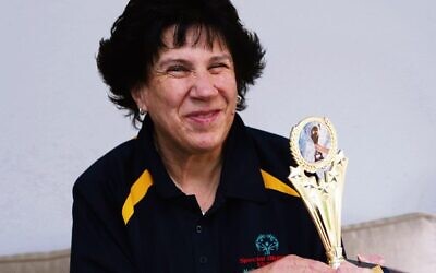 Rina Aufgang holding her trophy from the Special Olympics Committee last week. 
Photo: Peter Haskin