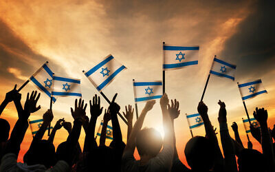 Silhouettes of People Holding Flag of Israel