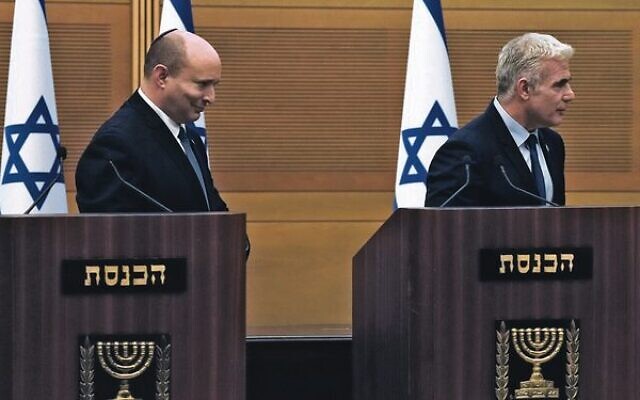 Israeli Prime Minister Naftali Bennett (left) and Foreign Minister Yair Lapid leave the podiums after their joint statement at the Knesset. 
Photo: AP Photo/Maya Alleruzzo