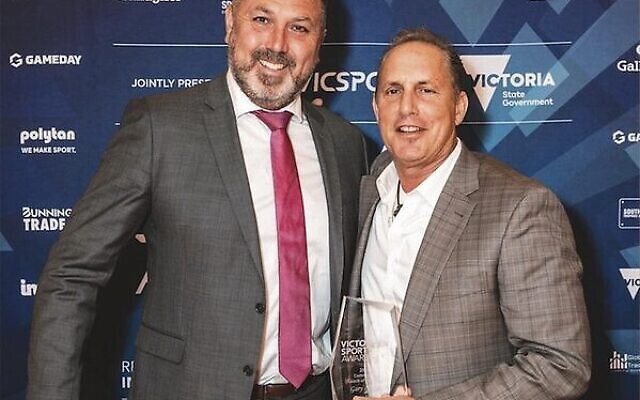 Gary Lasky (right) receiving his Victoria Sport award for community coaching from presenter Steve Van Leeuwen.