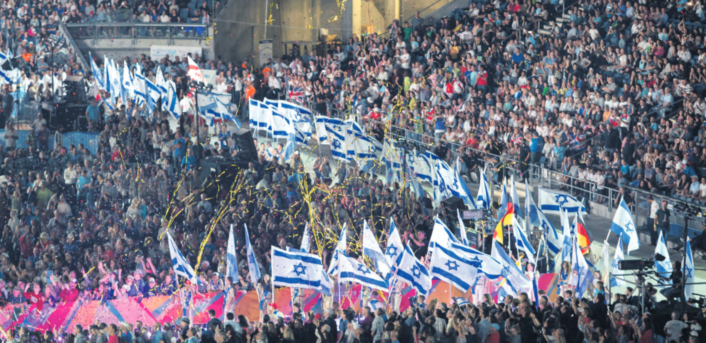 Israeli flags flying high at the 2017 Maccabiah Games opening ceremony at Teddy Stadium in Jerusalem. Photo: Julie Kerbel.