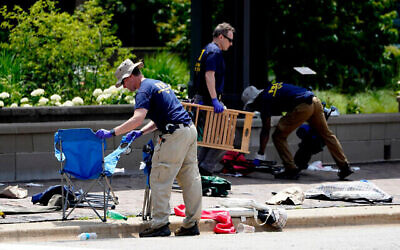 Members of the FBI's evidence response team remove personal belongings one day after a mass shooting in downtown Highland Park. Photo: AP Photo/Charles Rex Arbogast