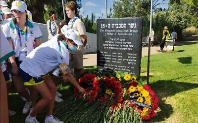Left: Australian team members laying wreaths and flowers at the 1997 Maccabiah Games bridge collapse memorial stone in Ramat Gan on July 11.
Right: The audience at the bridge memorial ceremony beside the Yarkon River.
