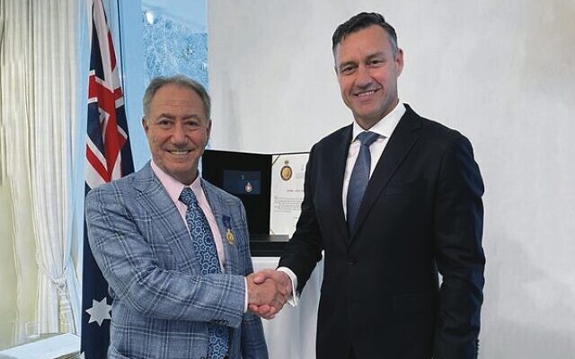 Australia's ambassador to Israel Paul Griffiths presents Danny Hakim with an Order of Australia (OAM) medal.