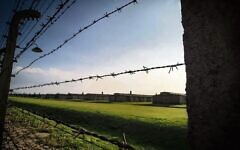 A fence and barracks at Auschwitz. Photo: MOTL