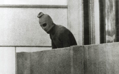 One of the defining images of the Munich Olympics in 1972: a member of the group that had taken the Israelis hostage seen on the apartment balcony in a face mask. Photo: Russell Mcphedran/The Sydney Morning Herald/Fairfax Media via Getty Images