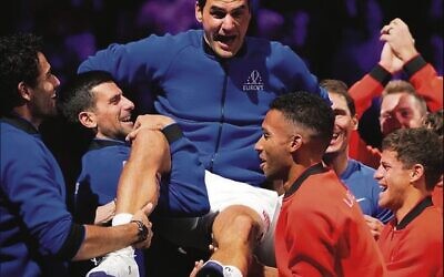 Roger Federer being lifted by players at the 2022 Laver Cup, his last event. Diego Schwartzman is on the right.