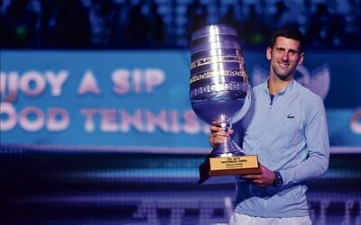 Novak Djokovic holding the 2022 Tel Aviv 
Watergen Open men's singles trophy on October 2. 
Photo: Israel Tennis Association
