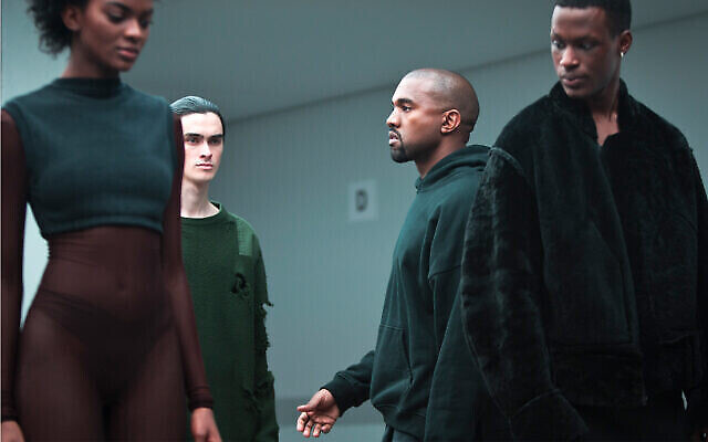 Kanye West, second from right, makes final rounds before the showing of the Kanye West Adidas Fall 2015 collection at Fashion Week in New York. Photo: AP Photo/Bebeto Matthews