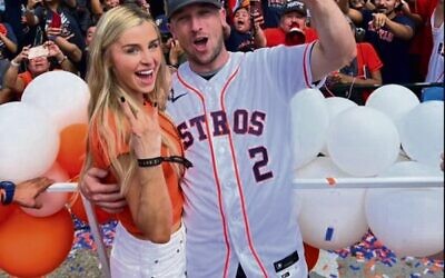 Houston batter Alex Bregman celebrating in front of Astros fans after the World Series win, with his wife Reagan.