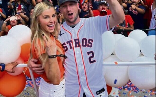 Houston batter Alex Bregman celebrating in front of Astros fans after the World Series win, with his wife Reagan.
