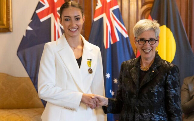Rhythmic gymnast Alexandra Kiroi-Bogatyreva (left) being presented with her Australian Sports Medal by Governor of Victoria Linda Dessau.