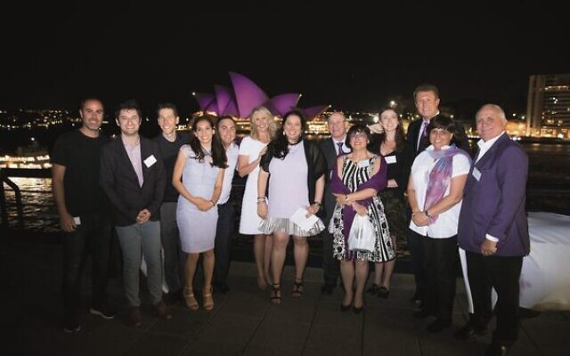 The #PurpleOurWorld family with ambassador Tracey Spicer and newsreader Peter Overton at a function held to mark the sails of the Sydney Opera House turning purple for pancreatic cancer.