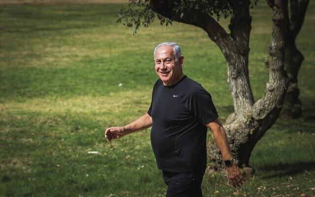 Likely prime minister Benjamin Netanyahu is all smiles during a morning walk the day after the election. 
Photo: Yonatan Sindel/Flash90