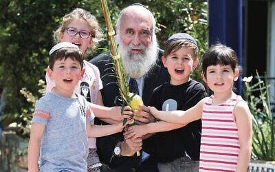Rabbi Aryeh Solomon in 2017 teaching kindergarten children about Succot. Photo: Noel Kessel