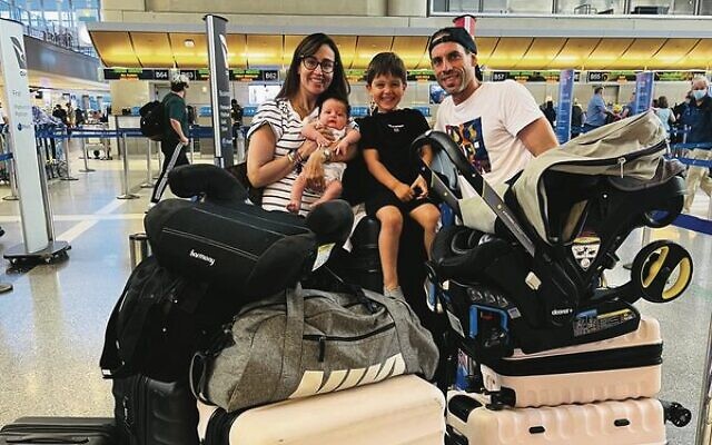 The Israel family returning home from Vancouver with their newborn son.