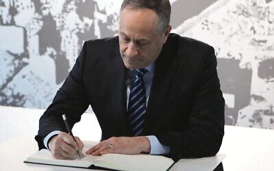 Douglas Emhoff signs a visitor book at the Topography of Terror museum in Berlin. Photo: US Embassy Berlin