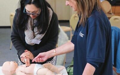 CHS's Hilary Jacobson (right) training a Mum for Mum volunteer in infant CPR.