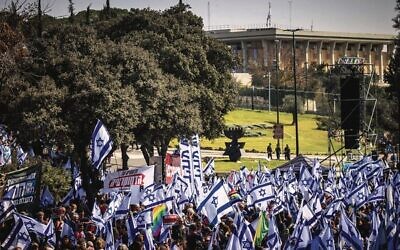 Thousands wave Israeli flags as they protest against the judicial overhaul at the Knesset on February 20, 2023. Photo: Yonatan Sindel/Flash90