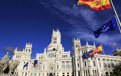 Cybele Palace, the Madrid City Hall, on Cibeles Square with the Cibeles Fountain, and Spanish and EU flags in foreground. Photo: Getty Images via JTA