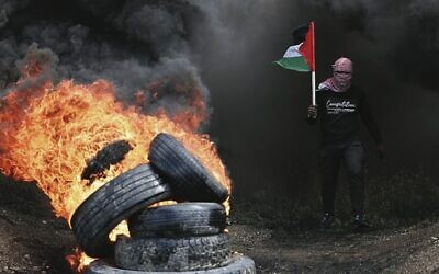 Palestinian protesters burn tyres during a Hamas protest east of Gaza City against the regional summit in Sharm el-Sheikh, Egypt. Photo: Mahmud Hams/AFP