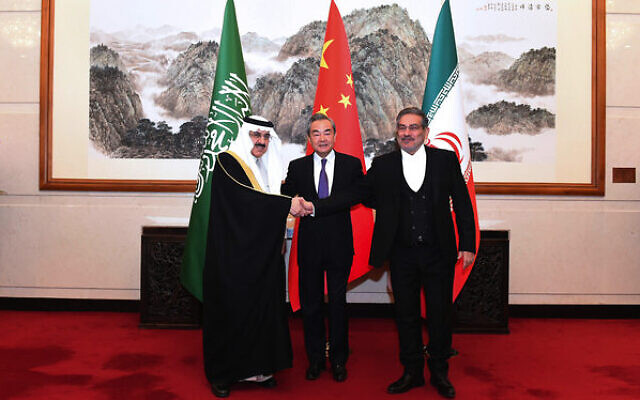 Ali Shamkhani, secretary of Iran's Supreme National Security Council (right) shakes hands with Saudi national security adviser Musaad bin Mohammed al-Aiban (left) as senior Chinese diplomat Wang Yi looks on. Photo: Luo Xiaoguang/Xinhua via AP