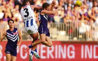 Harry Sheezel spoils the mark for the Dockers' Sam Switkowski at Perth's Optus Stadium on March 25. Photo: Paul Kane/Getty Images via AFL Photos