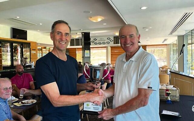 WA captain Ian Schwartz (left) presented with the Presidents Cup trophy by Maccabi Golf Australia president and team Victoria member Allen Garb.
