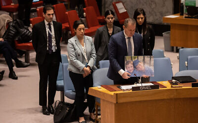 Israel's Ambassador to the United Nations Gilad Erdan (2R) and other Israeli delegates hold a moment of silence for terror victims brothers Yaakov and Asher Palley during the United Nations Security Council meeting on the situation in the Middle East, at the United Nations headquarters in New York City on February 20, 2023. Photo: Yuki IWAMURA/AFP