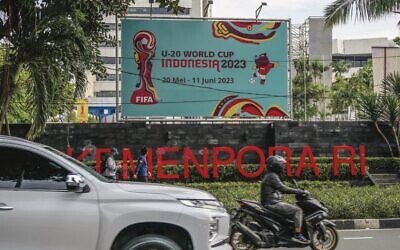 Motorists commute past a poster for the Indonesia 2023 FIFA Under-20 World Cup football tournament in Jakarta on March 30. Photo: Bay Ismoyo/AFP