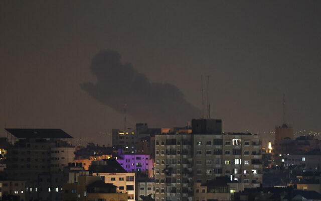 Smoke rises above buildings in Gaza City as Israel launched air strikes on the Palestinian enclave on late April 6, 2023. Photo: Mohammed ABED / AFP