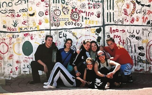 Volunteering in Shlomi. The IBC volunteer group helped the local children paint murals on the wall in town.