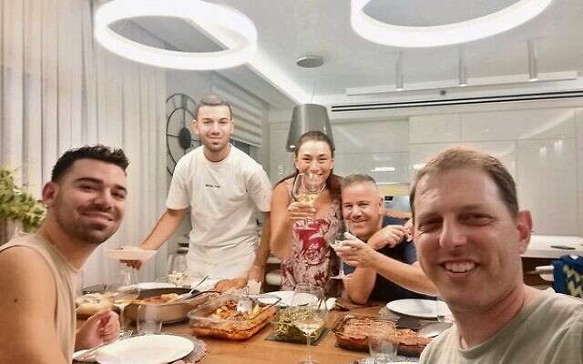 Shane (front, right) enjoying a family Shabbat dinner in Netanya.