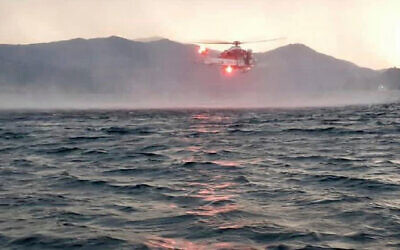 In this image released by the Italian firefighters, a helicopter searches for missing passengers after a tourist boat capsized in a storm on Italy’s Lago Maggiore in the northern Lombardy region, May 28, 2023. Photo: Vigili Del Fuoco via AP