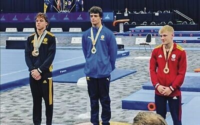 Uri Lev (centre) on the podium after winning a vault final.