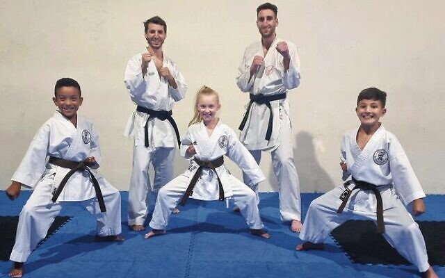 Richard Basckin (back left) and his Australian teammate Yonatan Freund, with young participants in the opening week of the duo's Miyaki Kan Karate East dojo.