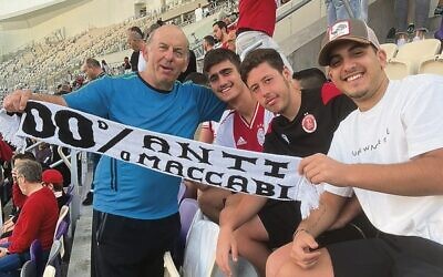 Danny Beran (left) enjoys a soccer match on his recent trip to Israel.