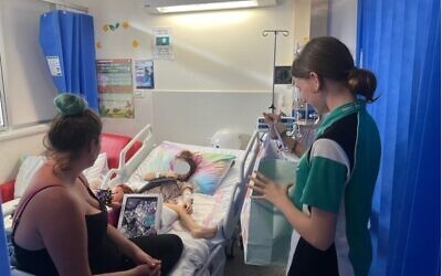 Patients at Cairns Base Hospital receiving gift packs from the teens.