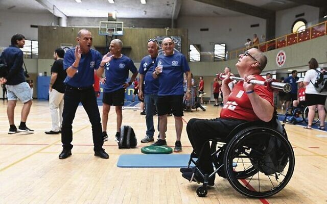A British athlete is cheered on by Israeli teammates and staff in the third Veterans Games in Tel Aviv on May 29. Photo: Beit Halochem UK