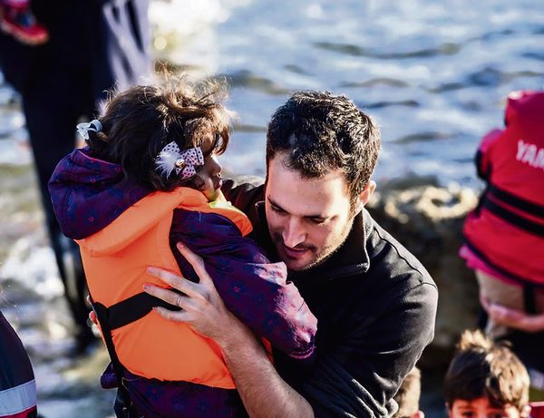 Yotam Polizer aids a Syrian refugee in Lesbos, Greece, in 2015. Photo: IsraAID