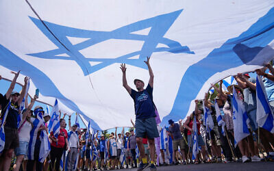 Demonstrators wave a large Israeli flag during a protest against the government outside the Knesset in Jerusalem, Monday, July 24, 2023 Photo: AP Photo/Ohad Zwigenberg
