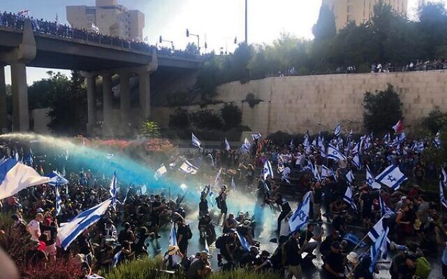Police fire water cannons at anti-overhaul protesters on Jerusalem's Begin Highway.
Photo: Times of Israel