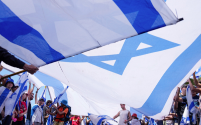 Demonstrators wave large Israeli flags during a protest against the Netanyahu government's overhaul of the judicial system, outside the Knesset in Jerusalem, on Monday, July 24, 2023, as parliament passed the 'reasonableness' law. Photo: AP Photo/Ohad Zwigenberg
