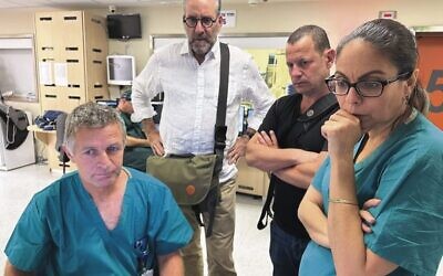 Daniel Goldman and Andrew Shostak (centre left and right) visit Hadassah hospital in Tel Aviv.