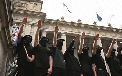 Neo-Nazis outside Parliament in Melbourne on Saturday, March 18. 
Photo: AAP Image/James Ross