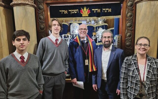 Students and staff with Rabbi Glasman in front of the Torah Scrolls.
  Photo: Paul Topol.