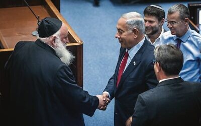 Benjamin Netanyahu shakes hands with United Torah Judaism party leader Yitzhak Goldknopf in the Knesset last November. Photo: Yonatan Sindel/ Flash90