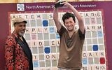 David Eldar raises the 2023 world Scrabble championship trophy. Photo: NASPA